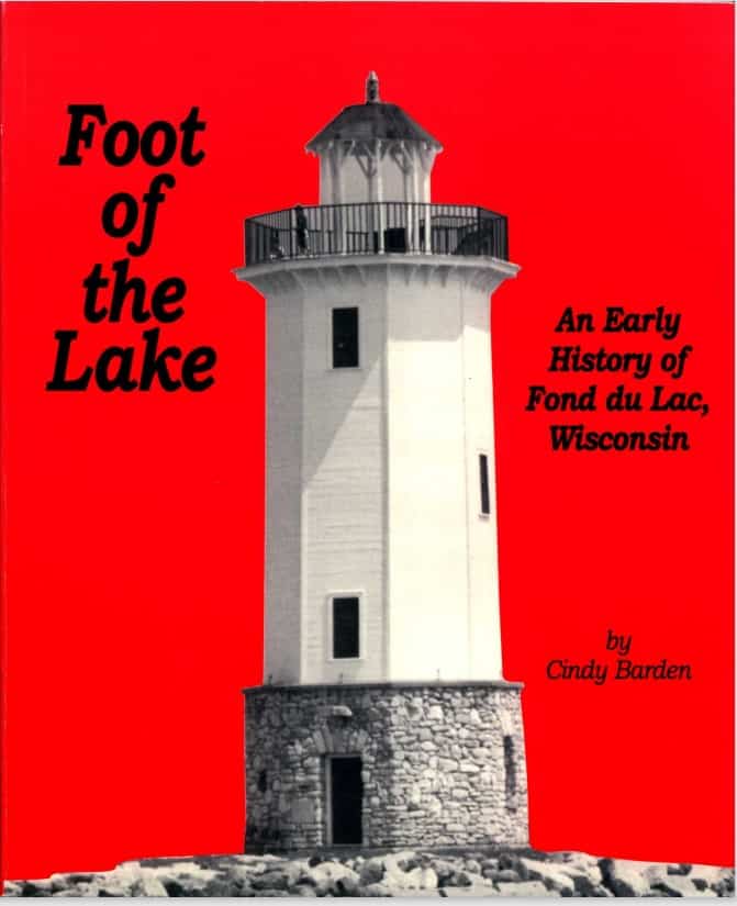 Book cover for Foot of the Lake: An Early History of Fond du Lac Wisconsin by Cindy Barden. It features an image of a lighthouse grayed out. The background is red.