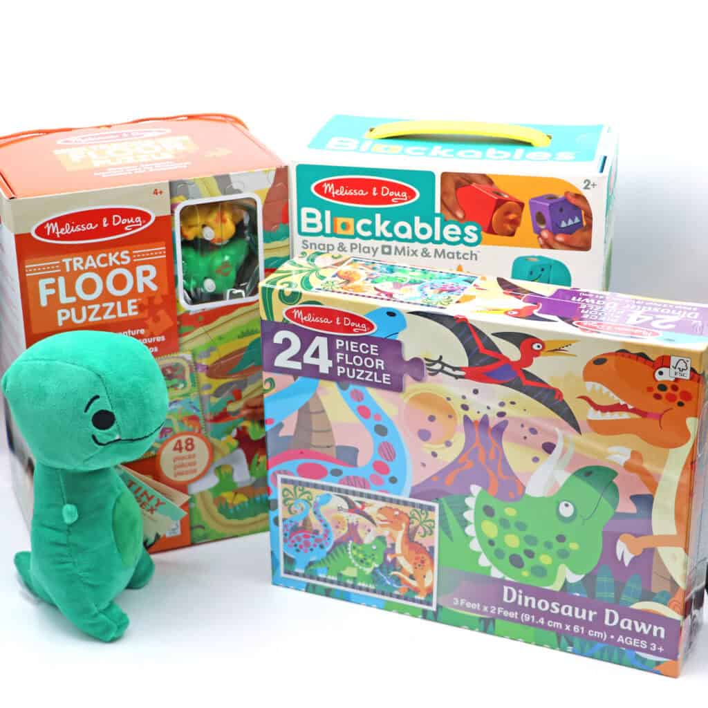 A series of dinosaur puzzles and a plush dinosaur